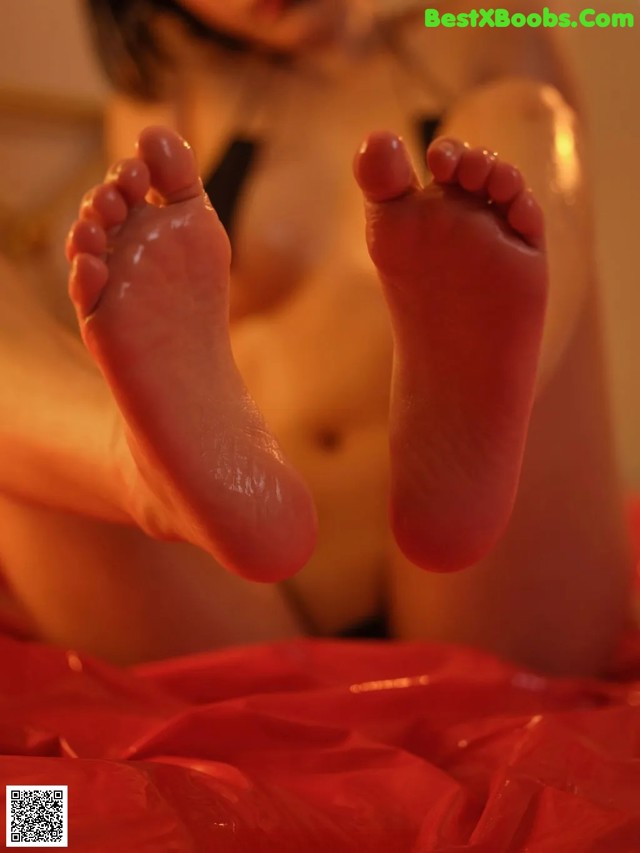 A close up of a person's feet on a bed.