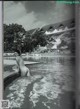 A black and white photo of a naked woman in a pool.