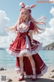 A woman in a red and white dress standing on a beach.