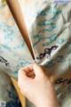 A close up of a person's hand holding a piece of fabric.