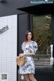 a woman standing in front of a coffee shop