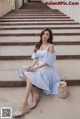 a woman sitting on the steps of a building