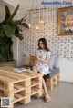 A woman sitting on a couch in a living room.