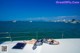 A woman laying on the deck of a boat in the water.